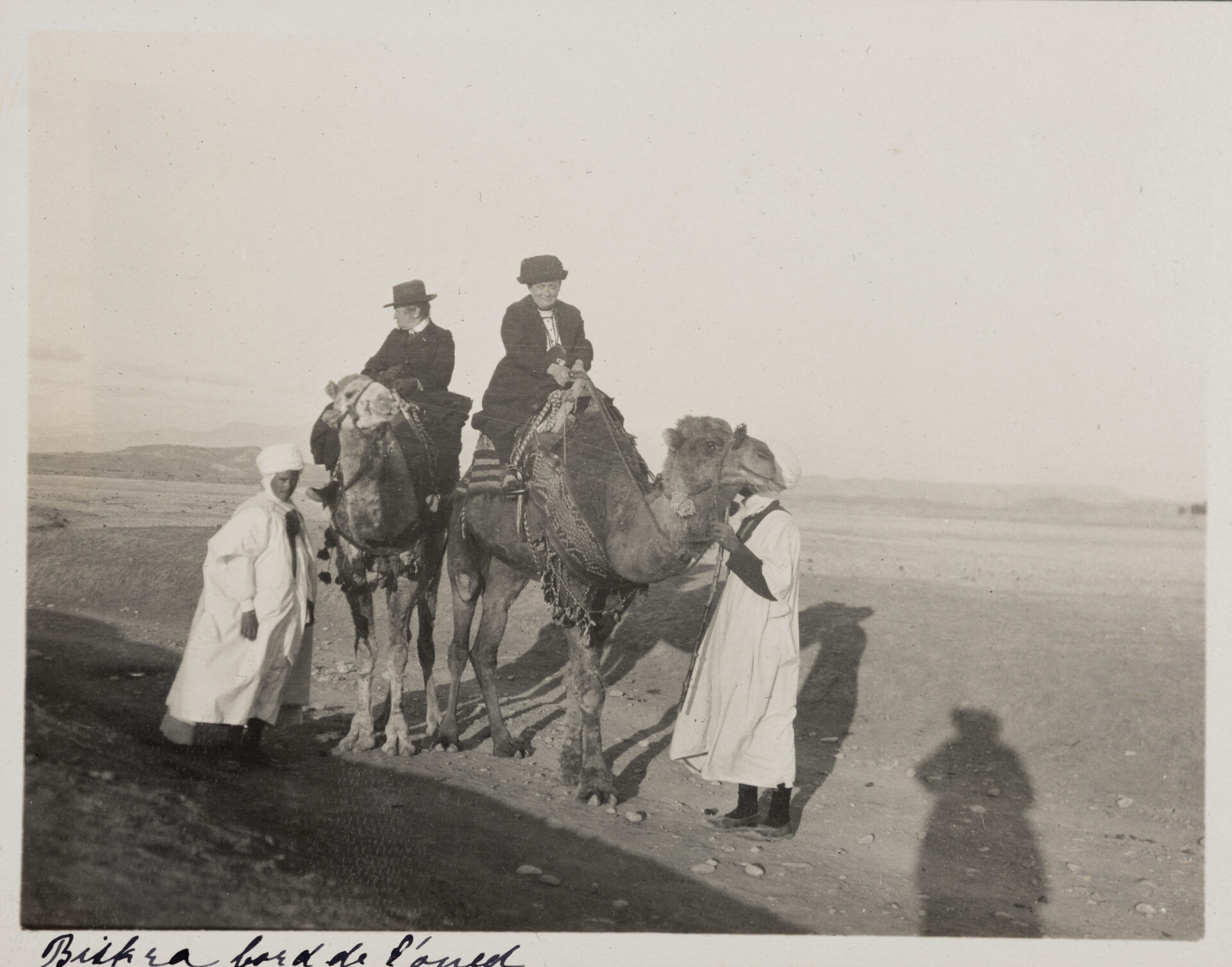 Ottilie W. Roederstein (l.) und Jeanne Smith (r.) auf Kamelen mit zwei einheimischen Führern in der Gegend um Biskra, Algerien, 22. November – 22. Dezember 1913, Fotografie